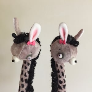 Image of May and June the Two-headed Tiny Giraffe Sisters