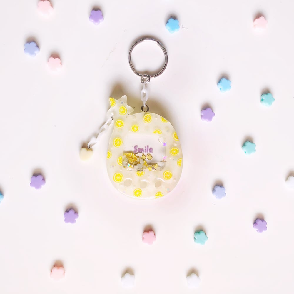 Image of citrus cheerful larger tamagotchi type keychain 