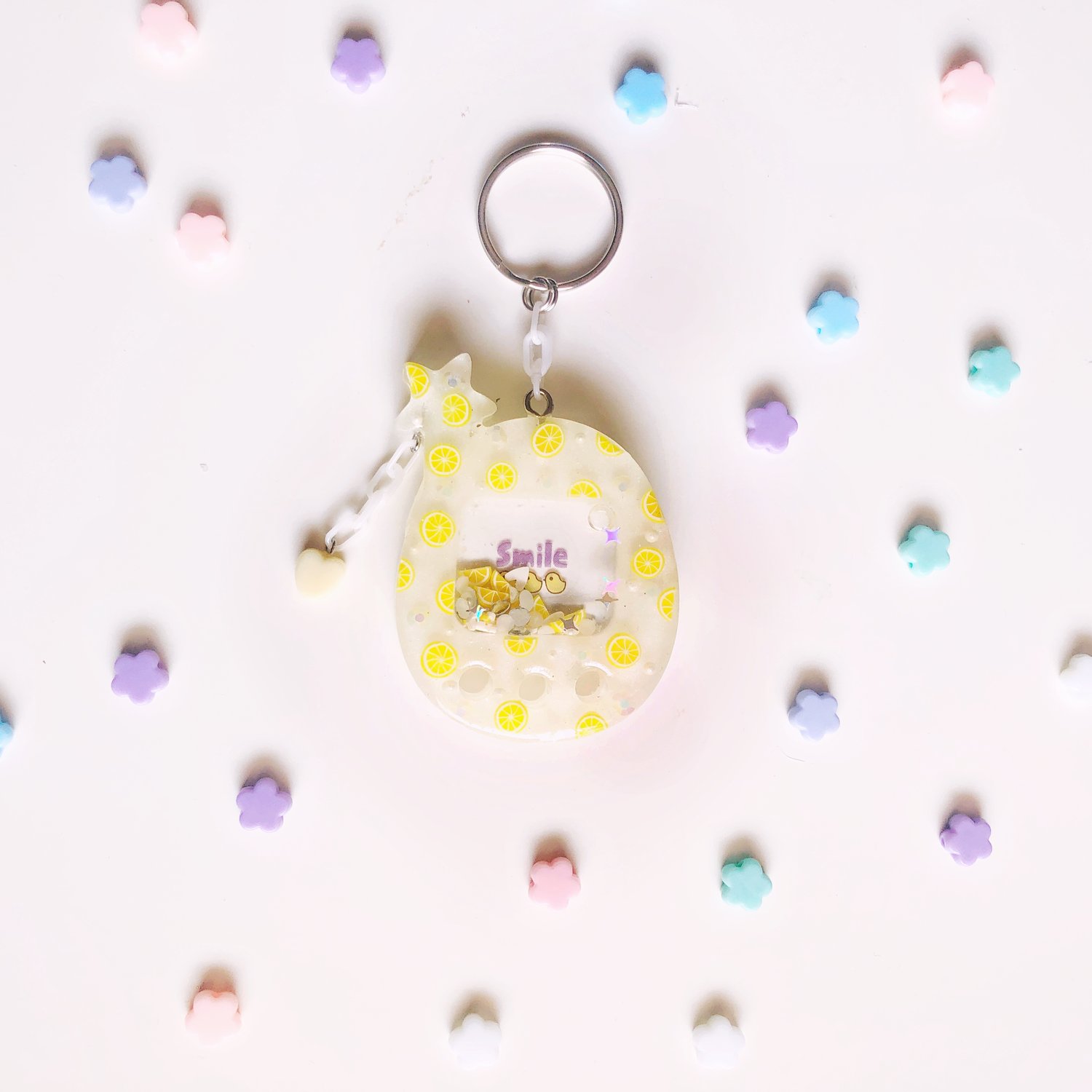 Image of citrus cheerful larger tamagotchi type keychain 