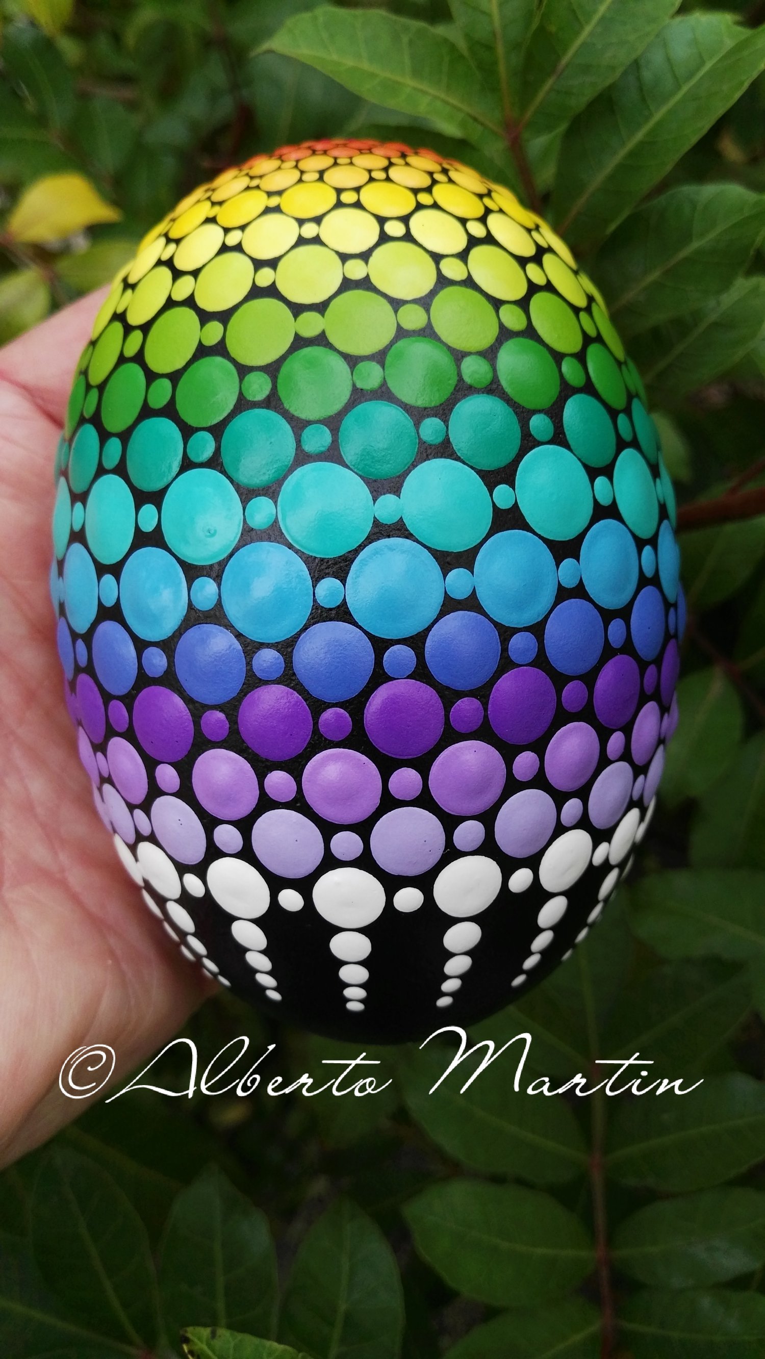 Image of Magical Rainbow dot art Painted egg-shaped stone by Alberto Martin