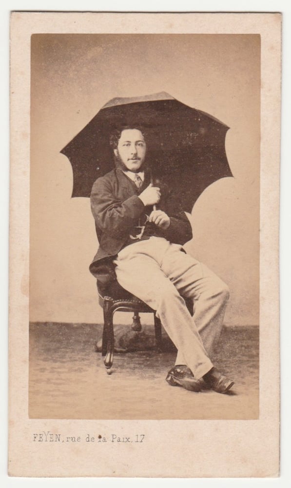 Image of Feyen: man posing with umbrella, Paris ca. 1860