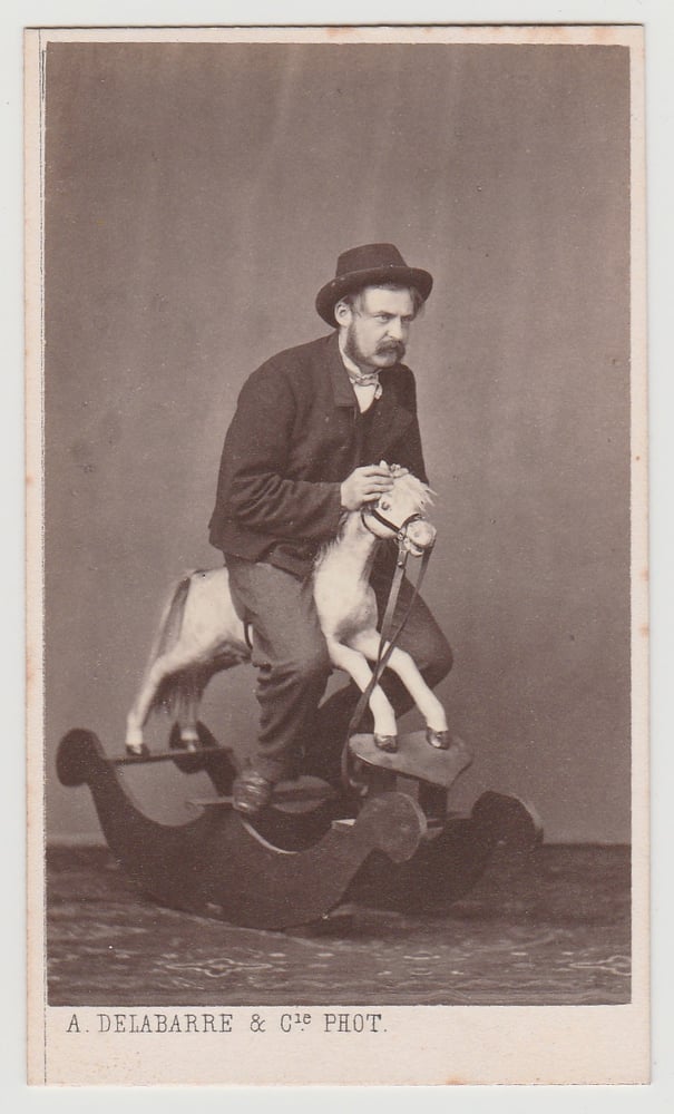 Image of Albert Delabarre: adult man on a rocking horse, Brussels ca. 1870
