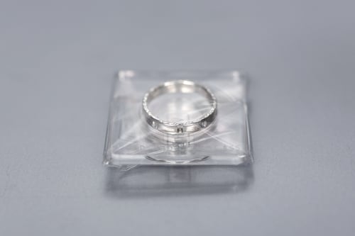 Image of silver ring for children with inscription in Latin