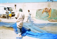 Fishermen folding net