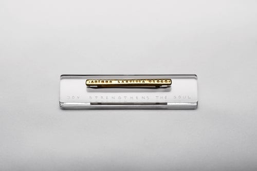 Image of gold plated silver brooch with inscription in Latin