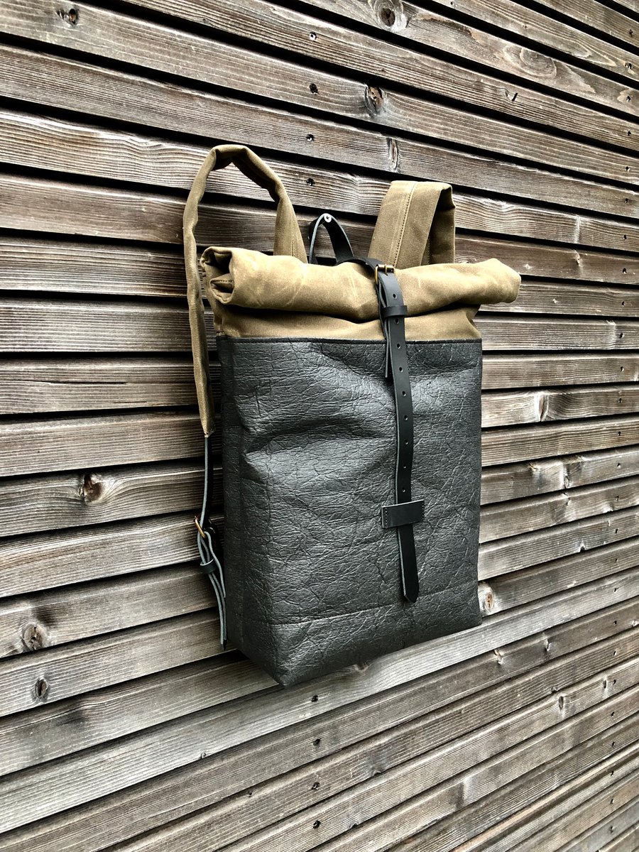 Image of Vegan backpack in black Piñatex™ and field tan waxed canvas with roll to close top