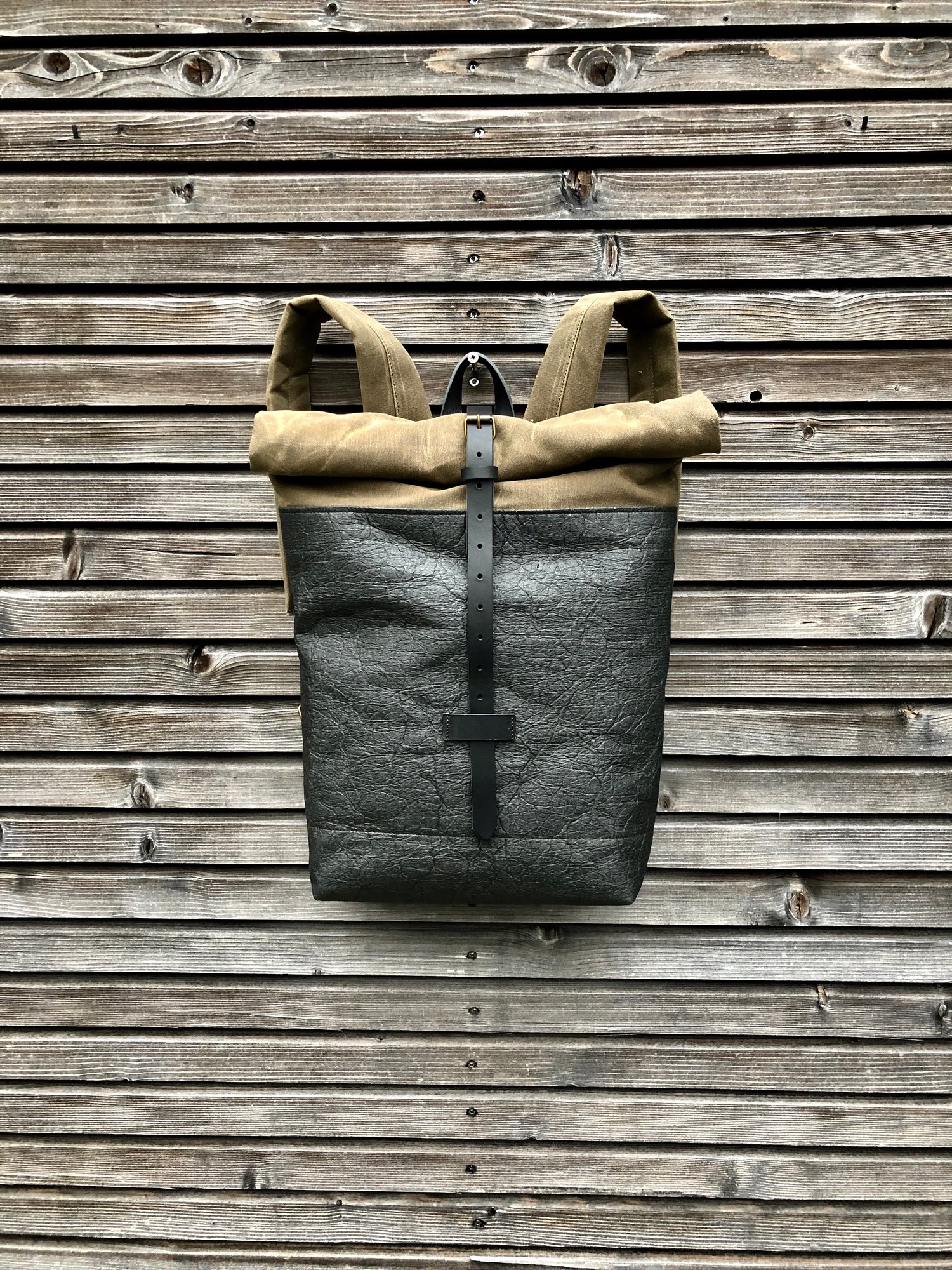 Image of Vegan backpack in black Piñatex™ and field tan waxed canvas with roll to close top