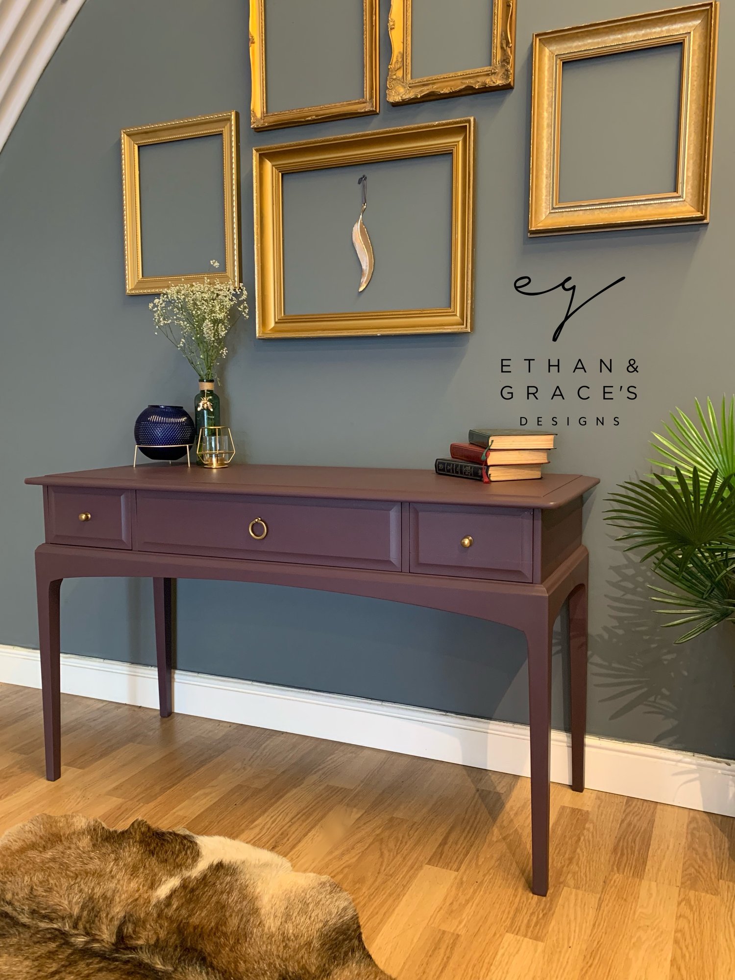 Image of A dark purple stag desk/dressing table 