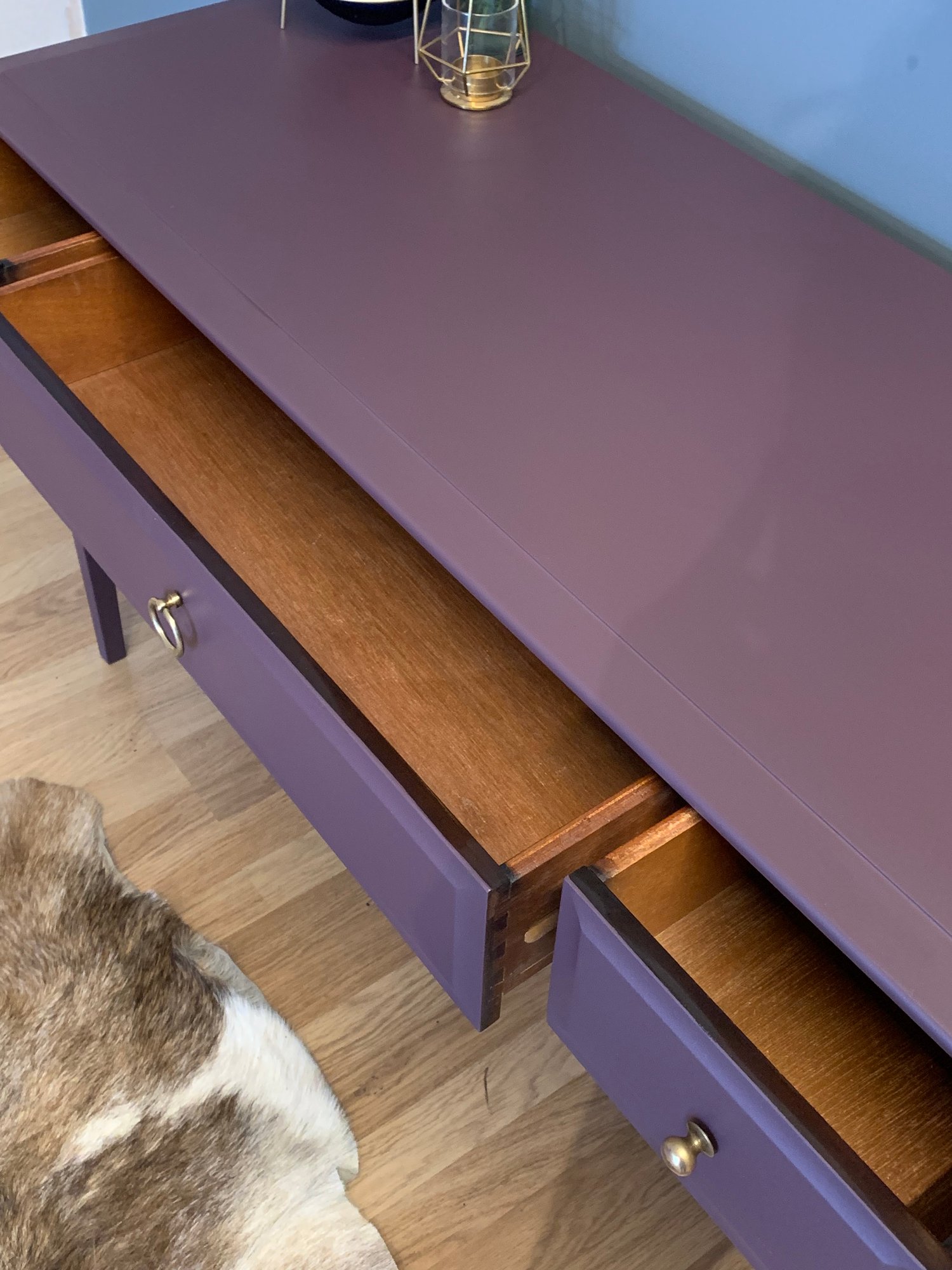 Image of A dark purple stag desk/dressing table