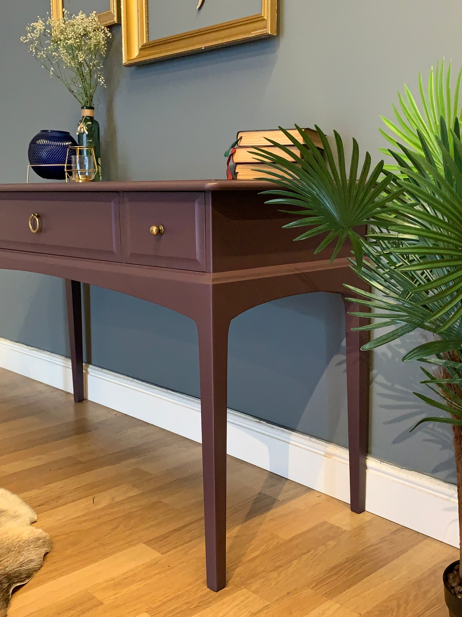 Image of A dark purple stag desk/dressing table