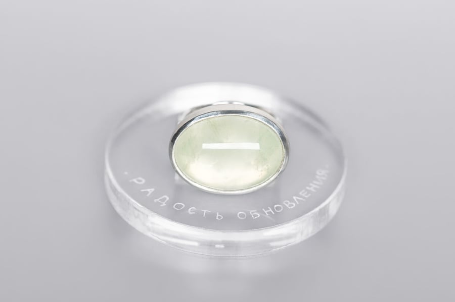 Image of silver ring with prehnite and inscription in Latin