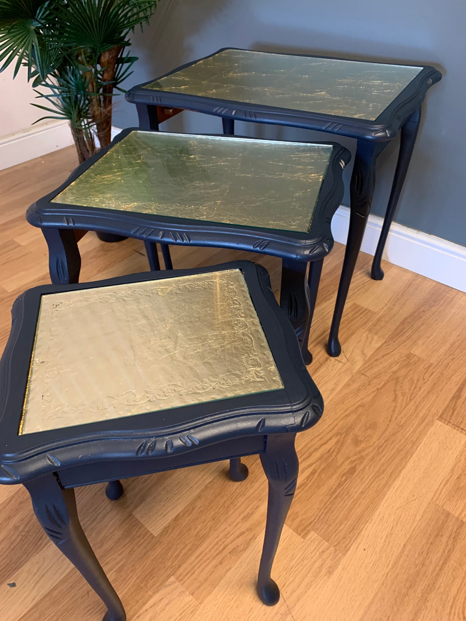 Image of A nest of tables in dark blue & gold leaf.