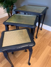 Image 2 of A nest of tables in dark blue & gold leaf.