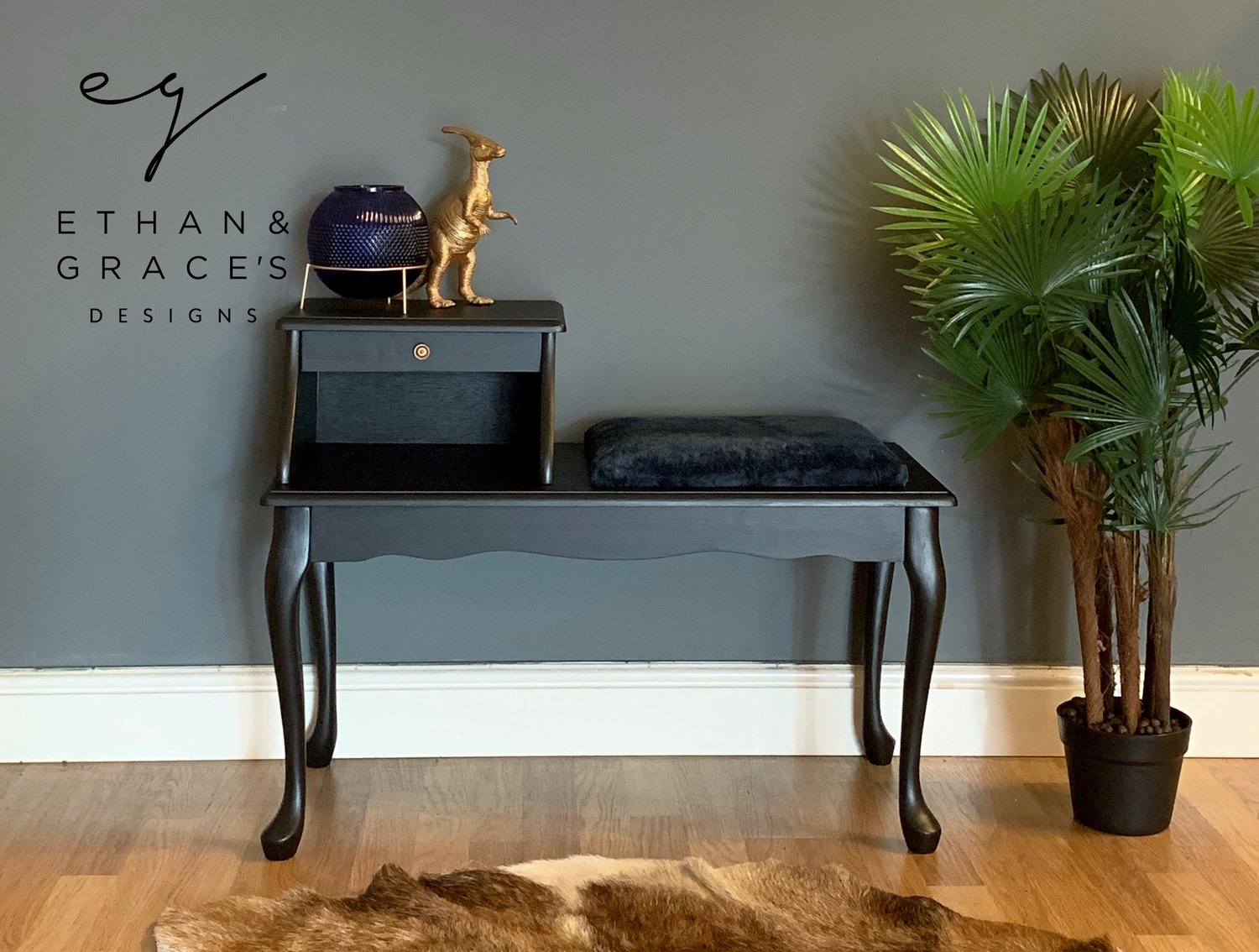 Image of A black telephone table with a navy blue fluffy seat.