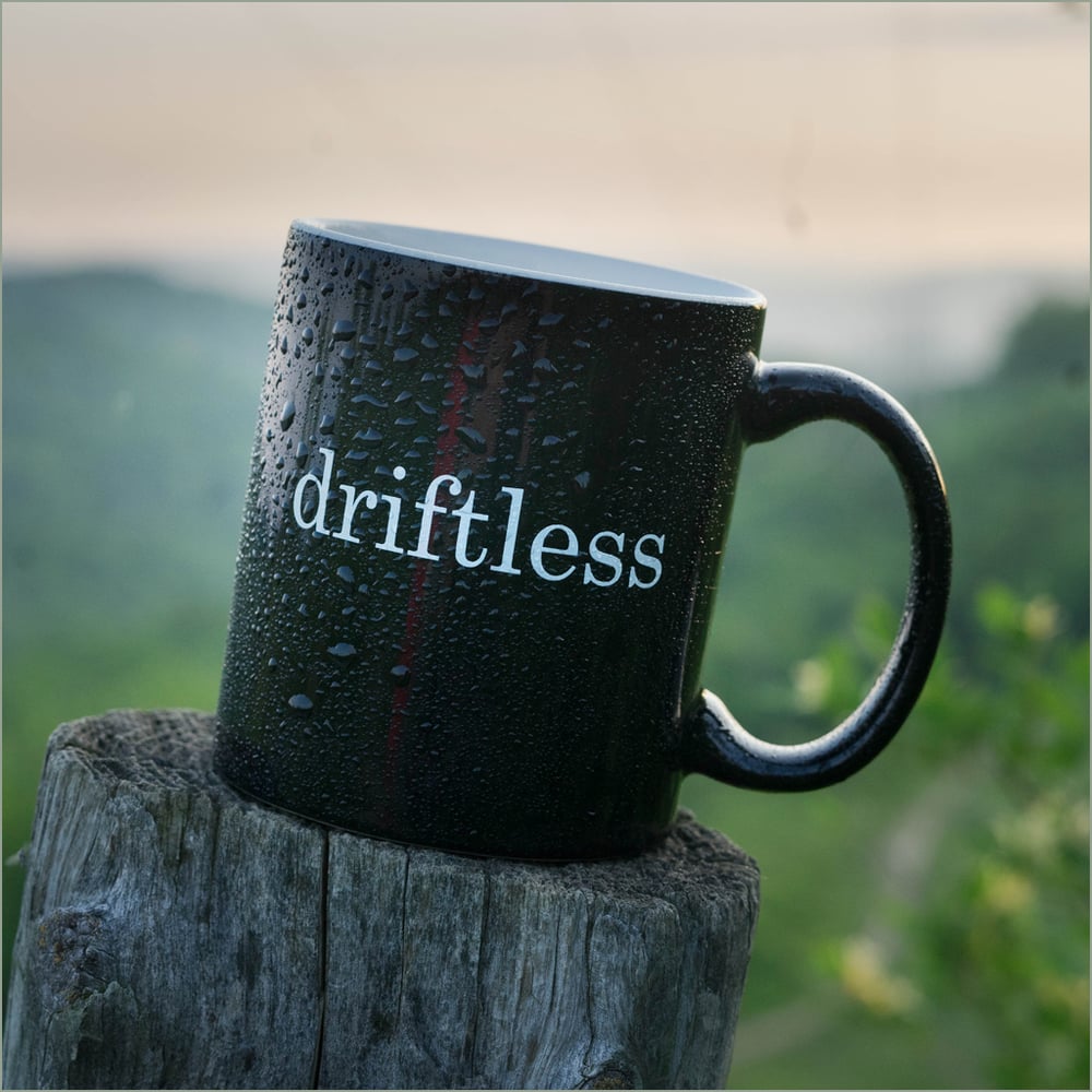 Image of 11 oz Mug with the Word "driftless" on It