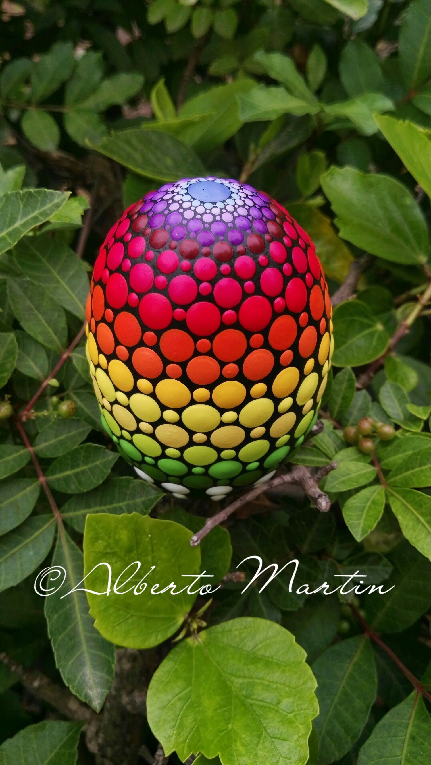 Image of Rainbow dot art Painted egg-shaped stone by Alberto Martin