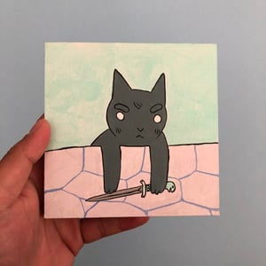 Image of Cat Looking Over Wall with Knife