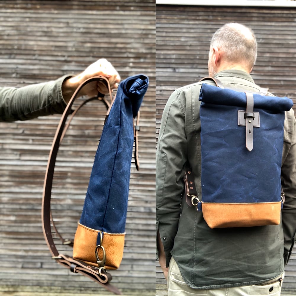 Image of Small waxed canvas backpack in navy blue with rolled top and leather shoulder straps