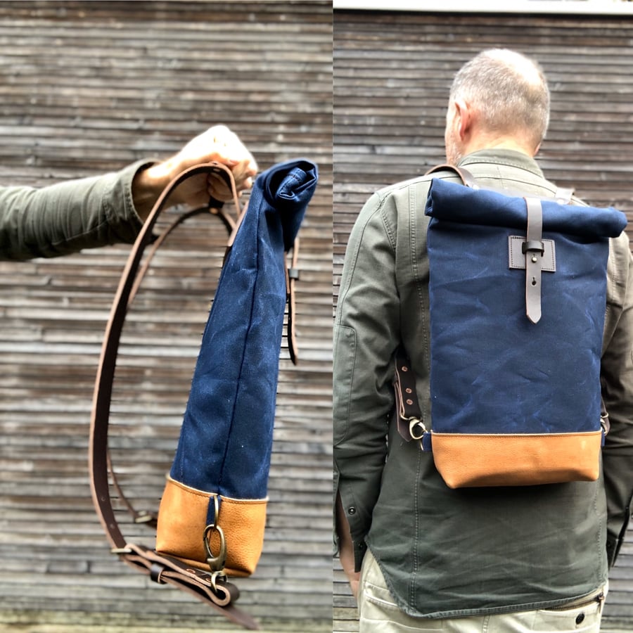 Image of Small waxed canvas backpack in navy blue with rolled top and leather shoulder straps