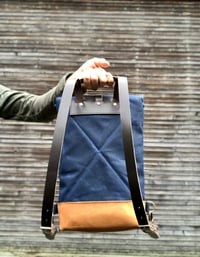 Image 4 of Small waxed canvas backpack in navy blue with rolled top and leather shoulder straps
