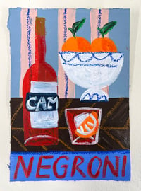 Negroni on stripes with Campari bottle