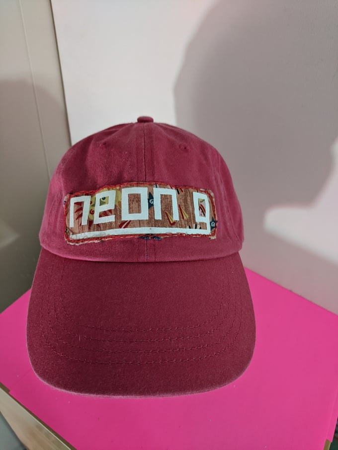 Image of neon g. dad hat in raspberry