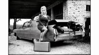 Dolly Parton standing beside Cadillac