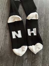 Image 4 of 603 black/white socks with NH on the bottom