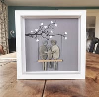 Image 2 of Family of three on swing