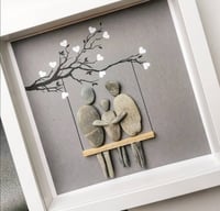 Image 4 of Family of three on swing