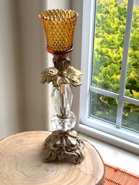 Image 2 of Vintage candlestand made of brass and lucite with a diamond cut amber votive. 