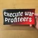 Image of Execute War Profiteers bumper sticker by Brad Rohloff