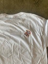 Image 3 of Jerry wearing a P hat shirt