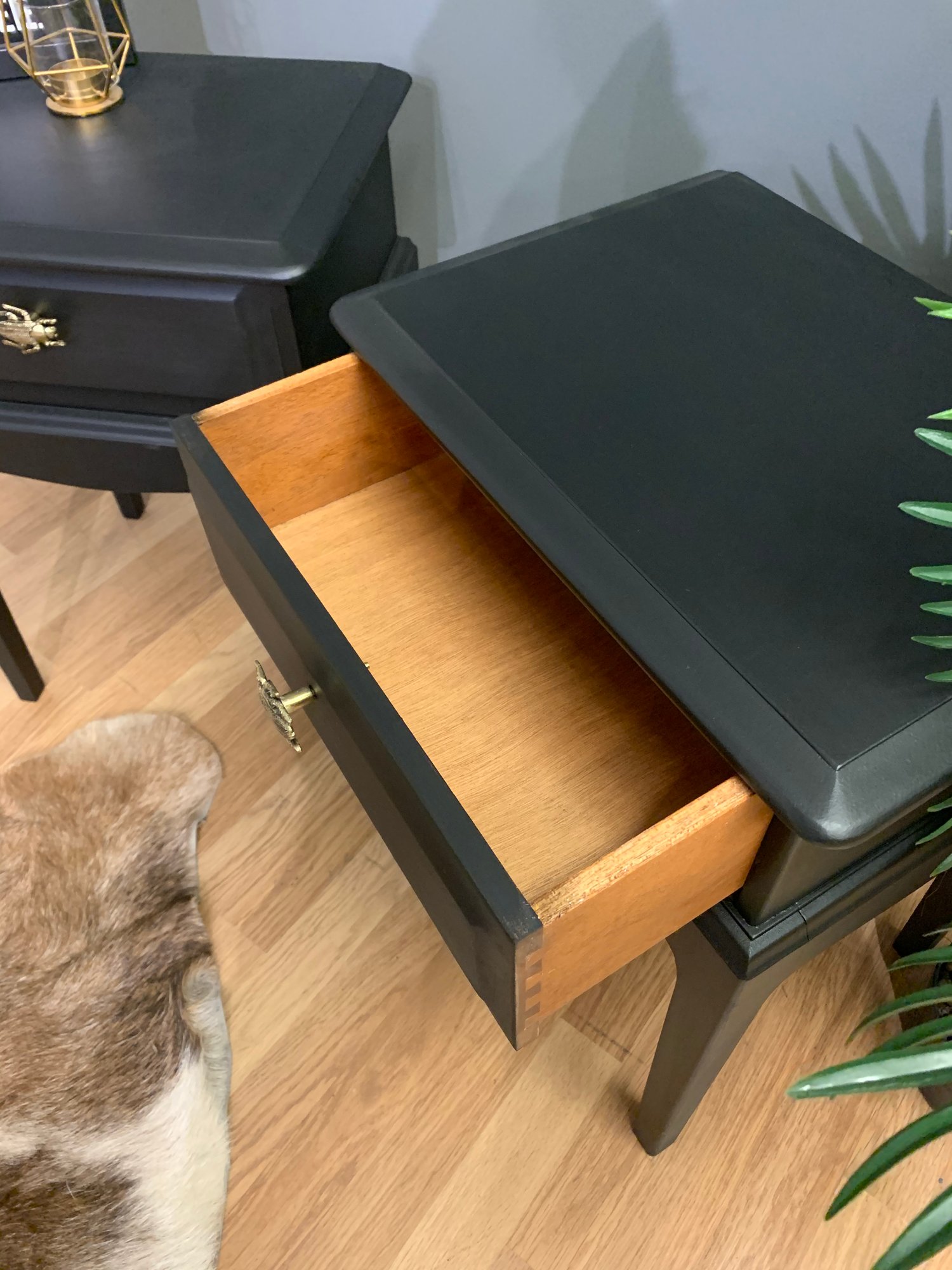 Image of A pair of black stag side tables
