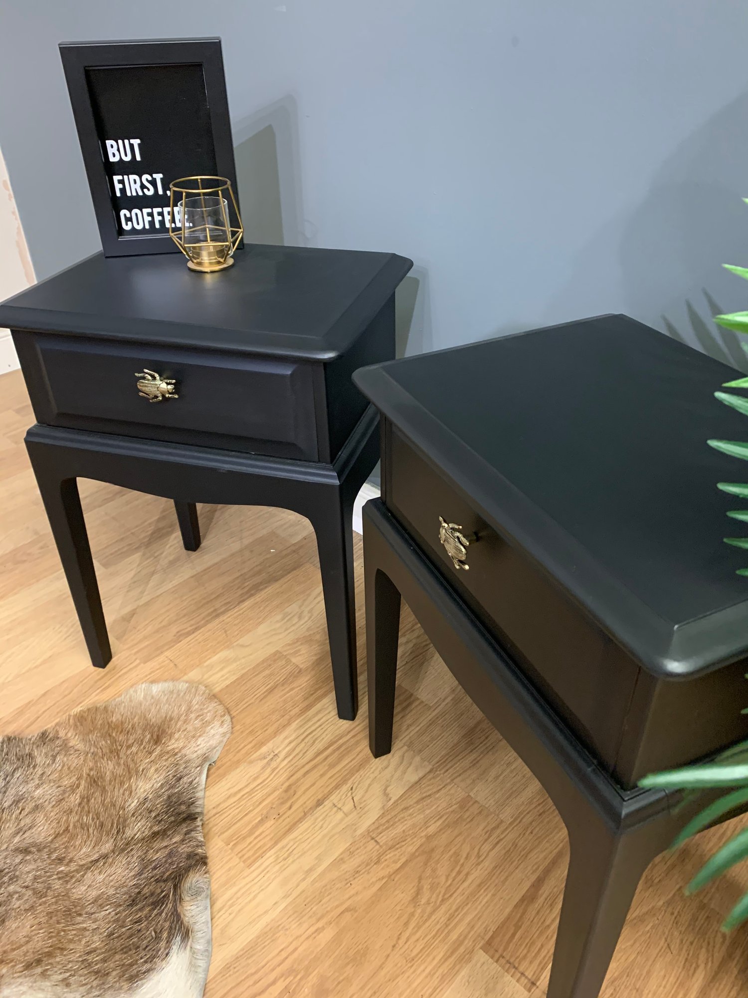 Image of A pair of black stag side tables 