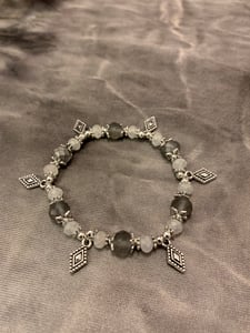 Image of Gray white and silver tone stretch bracelet with diamond shape charms