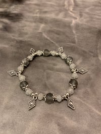 Image 1 of Gray white and silver tone stretch bracelet with diamond shape charms