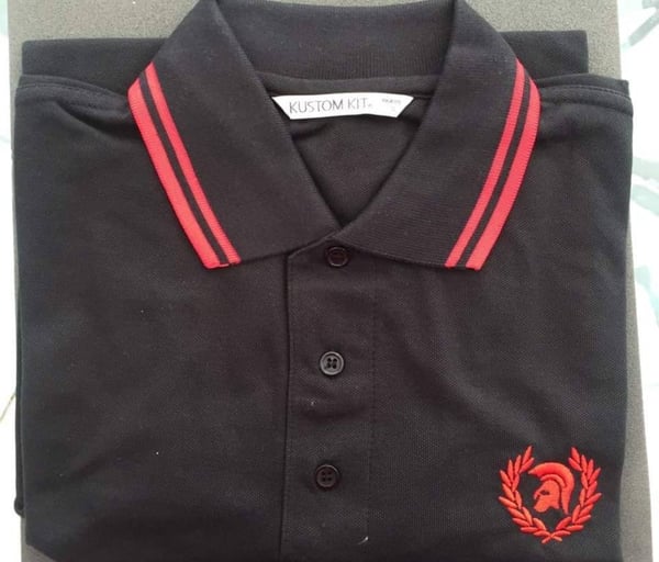 Image of Black and red trojan head in wreath