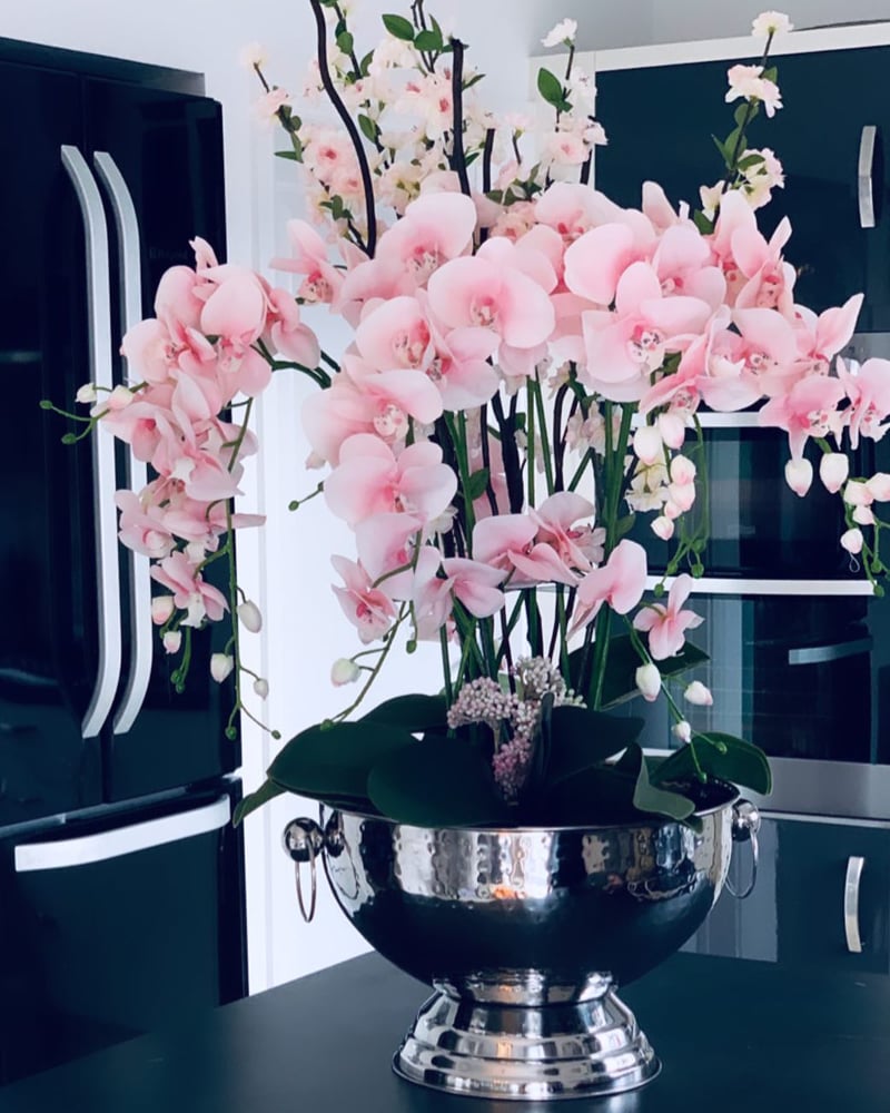Image of Tall pink orchids in a champagne bowl