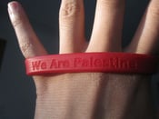 Image of Red "We Are Palestine" silicone bracelet.