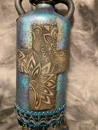 Image 2 of Cross altered bottle, blue bronze and black with beaded fringe. Night light .