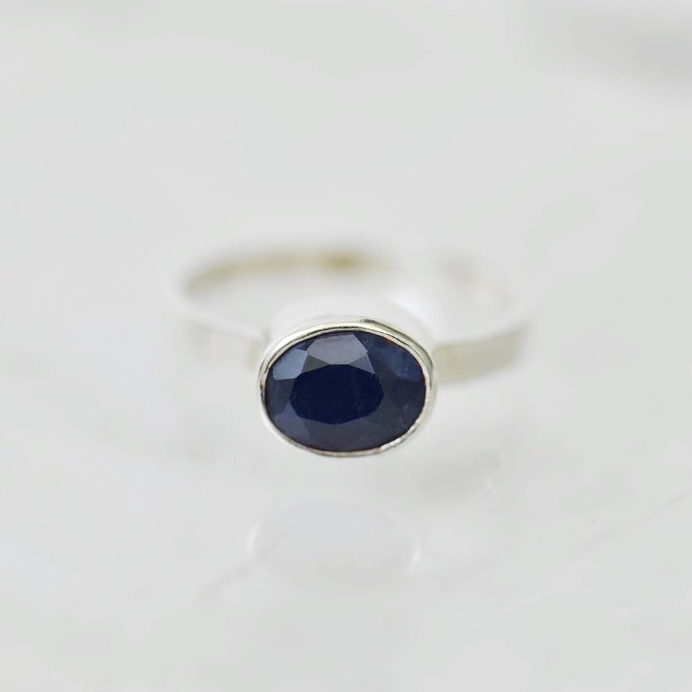 Image of Light Blue Sapphire oval cut flat band silver ring