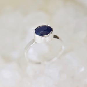 Image of Light Blue Sapphire oval cut flat band silver ring