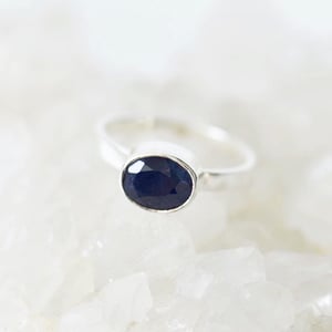 Image of Light Blue Sapphire oval cut flat band silver ring