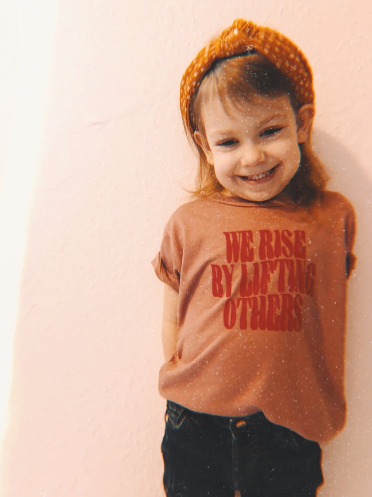 Image of We rise by lifting others kids tee 