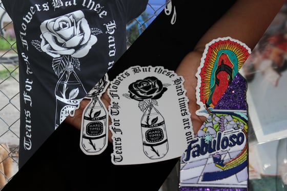 Image of the shirt, pin and sticker pack