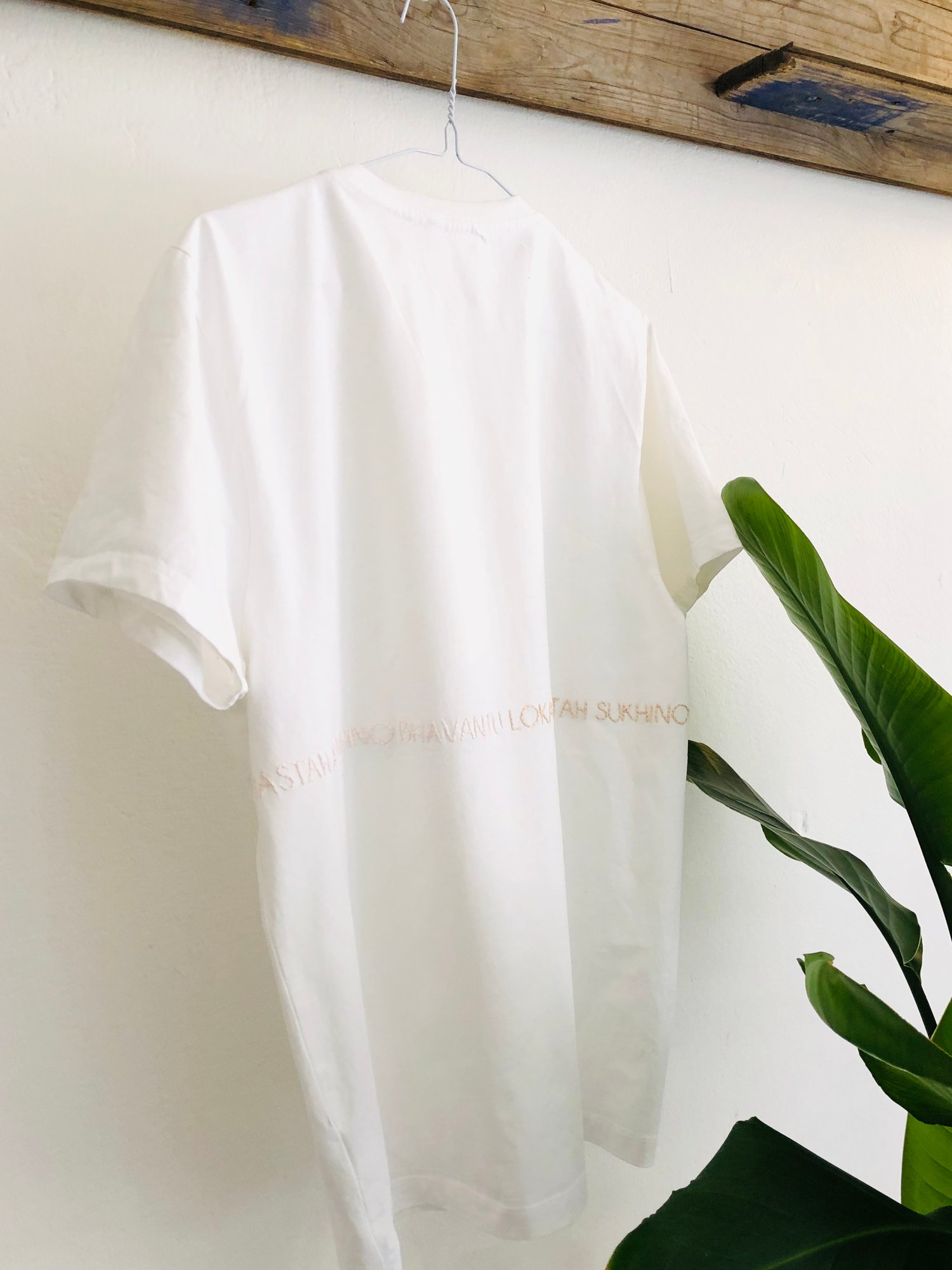 Image of LOKAH SAMASTAH SUKHINO BHAVANTU – wrapped – light blue/beige/rose – white unisex t-shirt