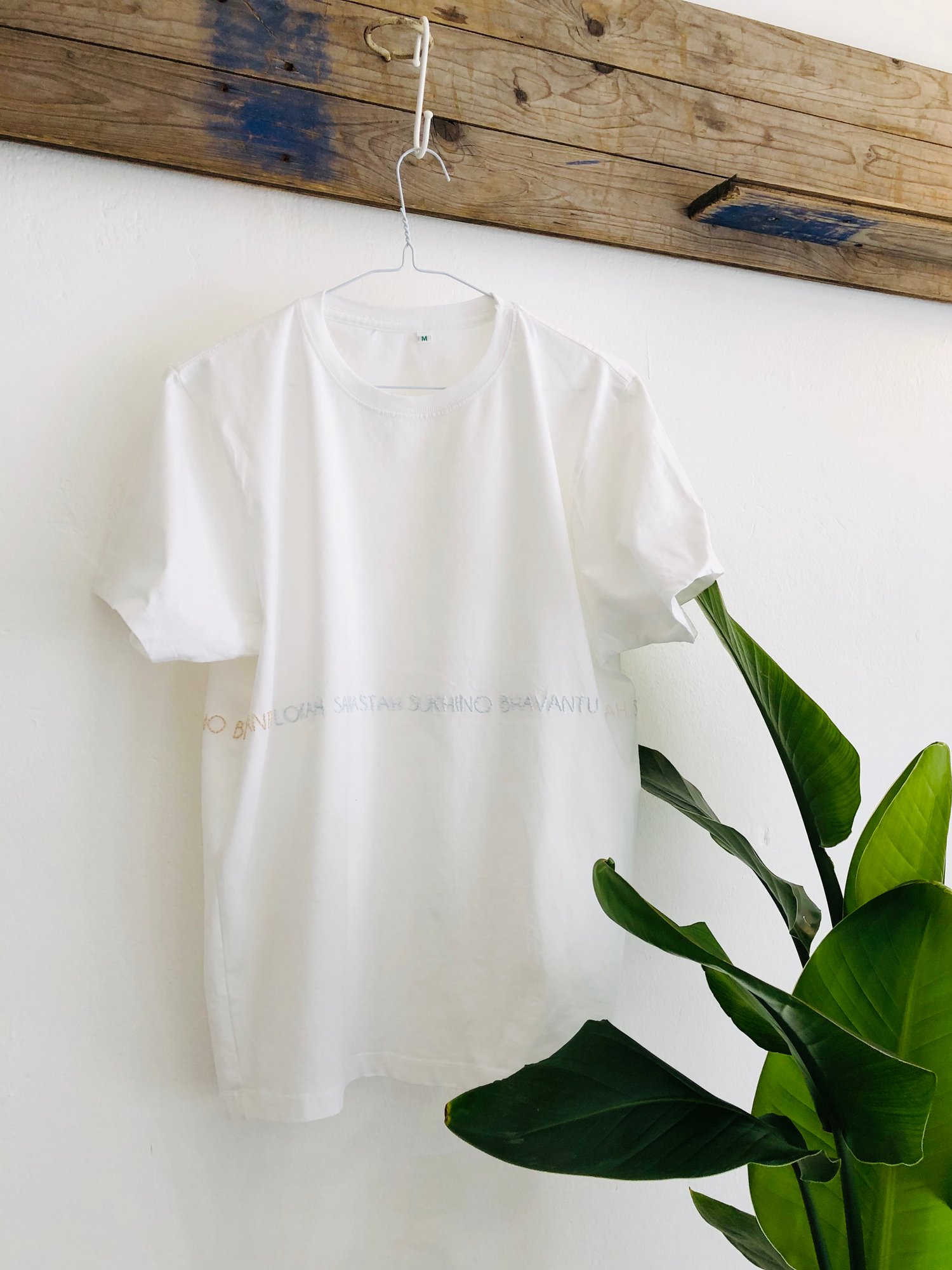 Image of LOKAH SAMASTAH SUKHINO BHAVANTU – wrapped – light blue/beige/rose – white unisex t-shirt