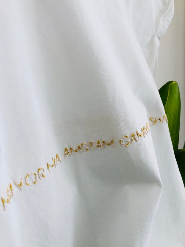 Image of OM ASATOMA SAD GAMAYA – wrapped – mustard yellow/rose – white t-shirt w/ rolled-up sleeves
