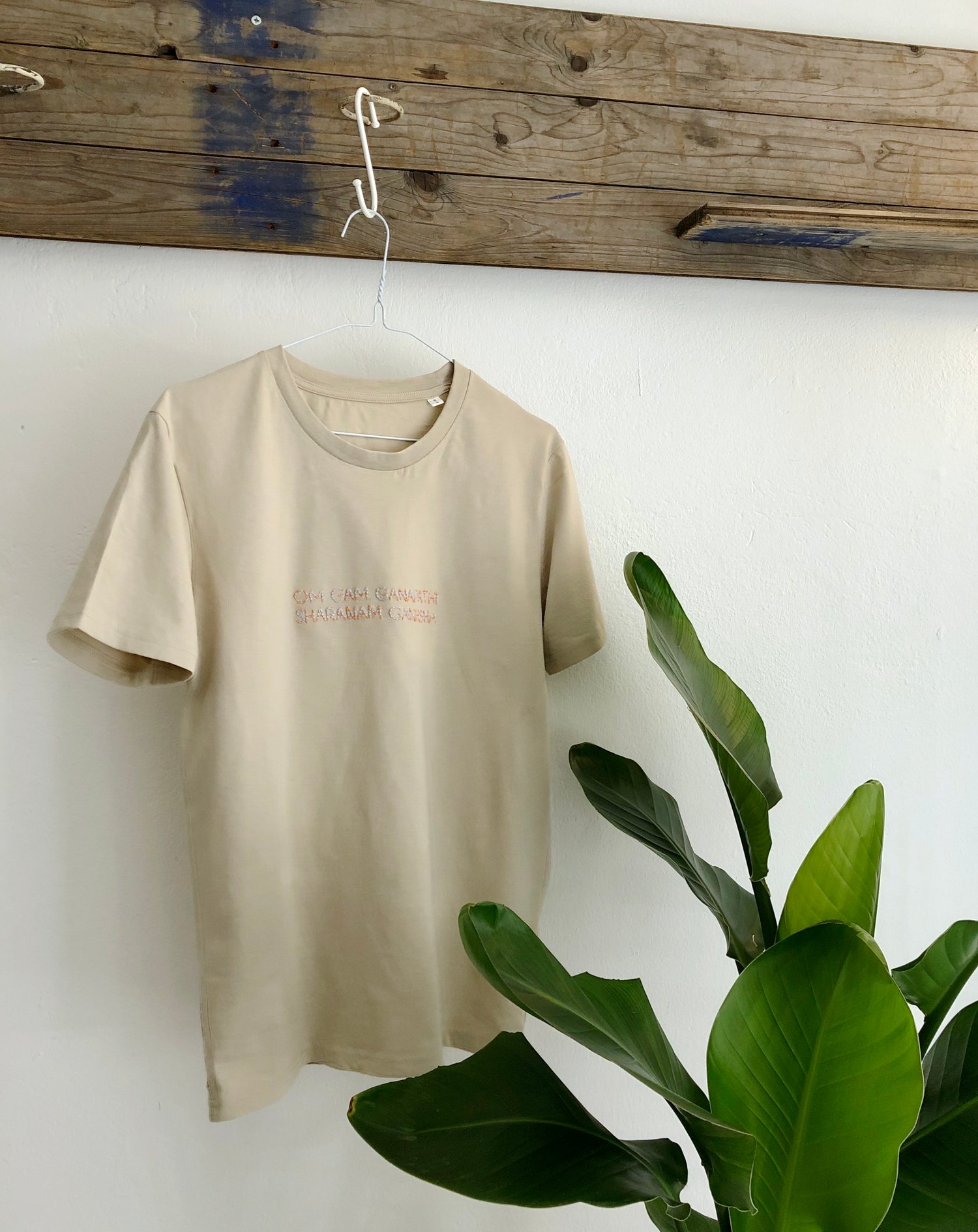 Image of OM GAM GANAPATHI – lilac/orange – beige unisex t-shirt